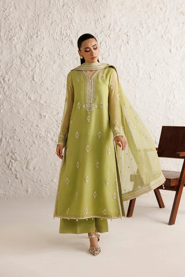 Model wearing luxury embroidered olive colored chiffon suit by a Pakistani brand in Australia
