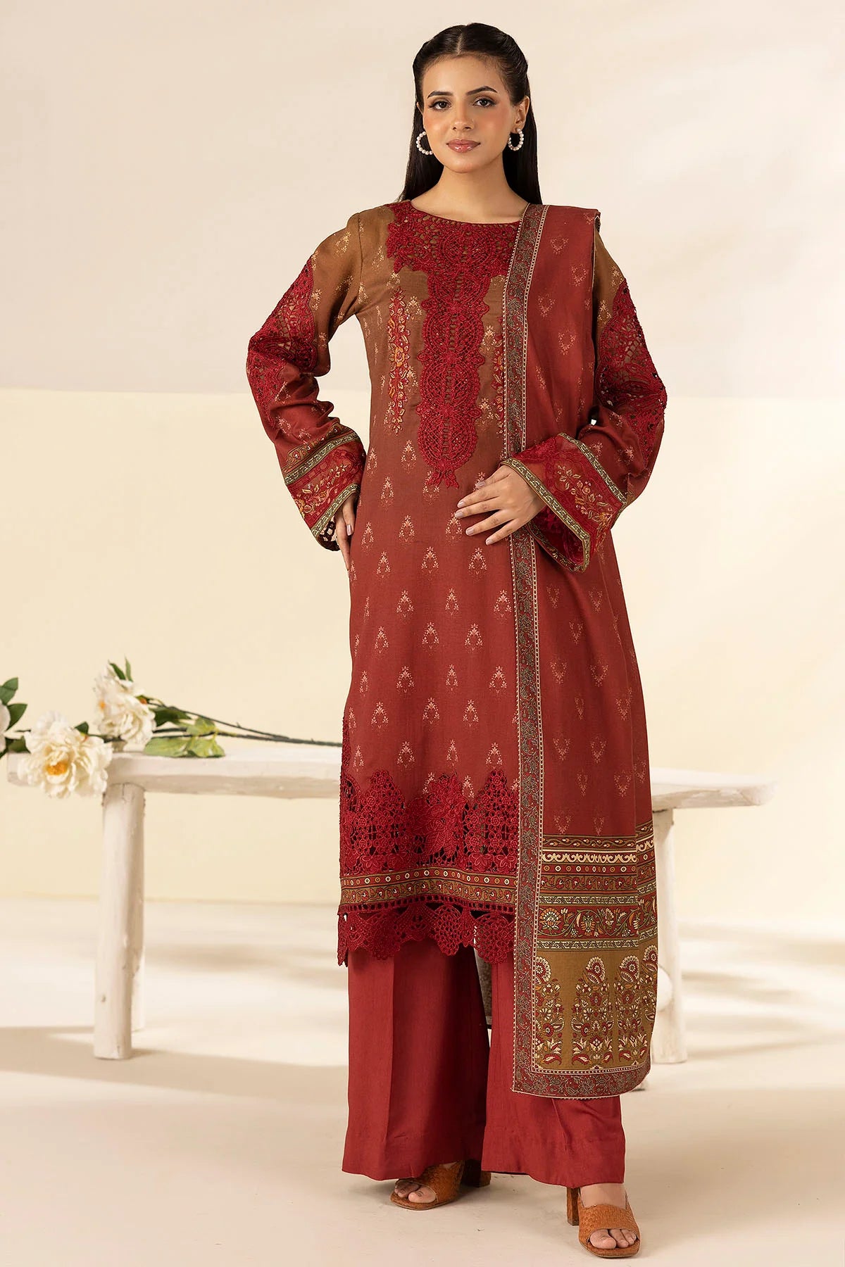 Woman wearing a red and gold traditional outfit with a white background