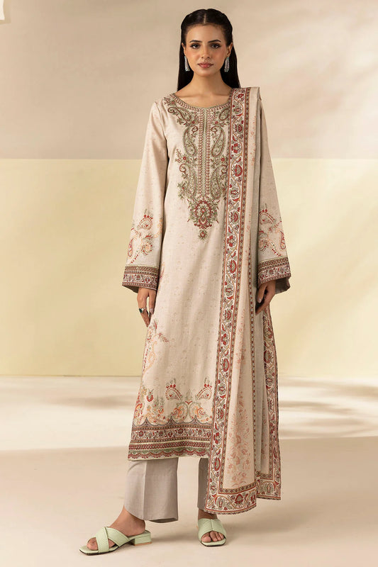 Woman wearing a traditional outfit with intricate embroidery on a plain background