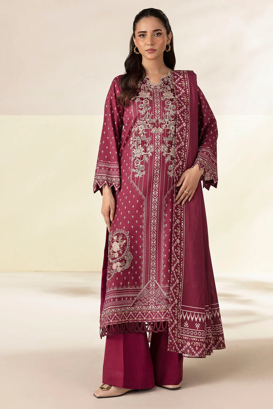Woman wearing a maroon embroidered traditional outfit on a beige background