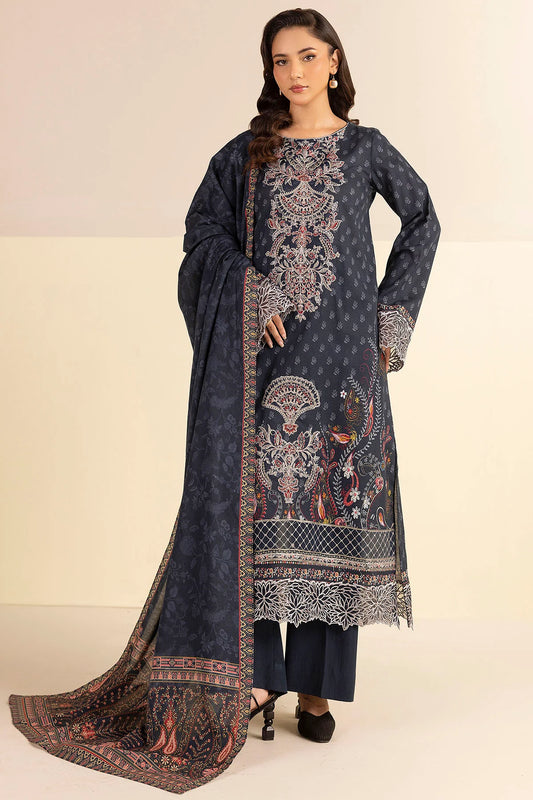 Woman wearing a dark blue embroidered traditional outfit with a matching dupatta on a beige background