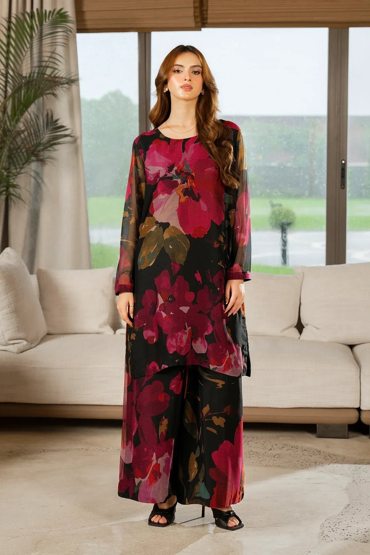 Woman wearing a floral coord dress in a modern living room